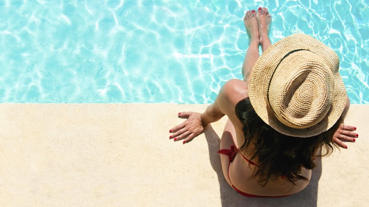 women sitting by the pool